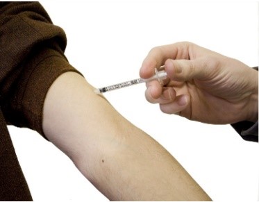 Person getting vaccine shot in arm